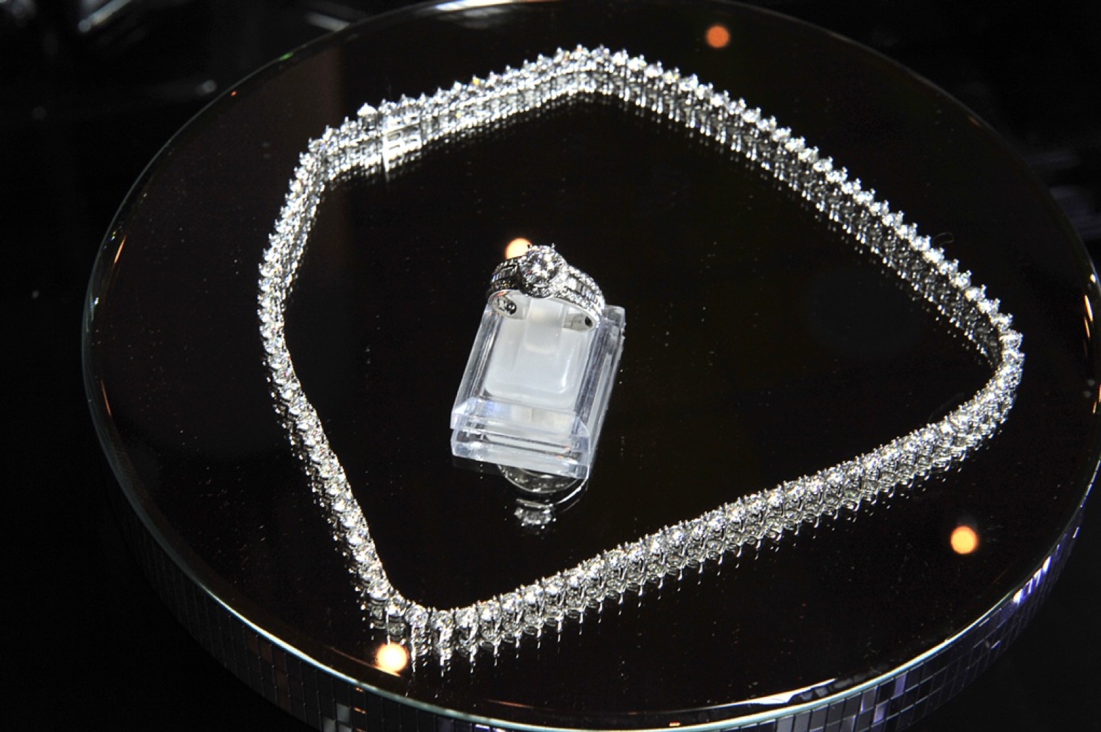 A diamond riviere and an emerald cut ring, photographed for the house